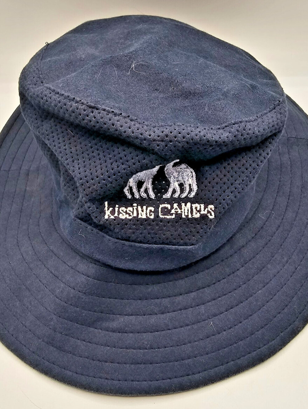 Mens Blue mesh bucket hat with a "Kissing Camels" Golf Club logo